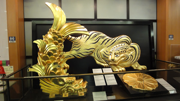 art pieces of the golden fish with a dragon's head and a golden tiger